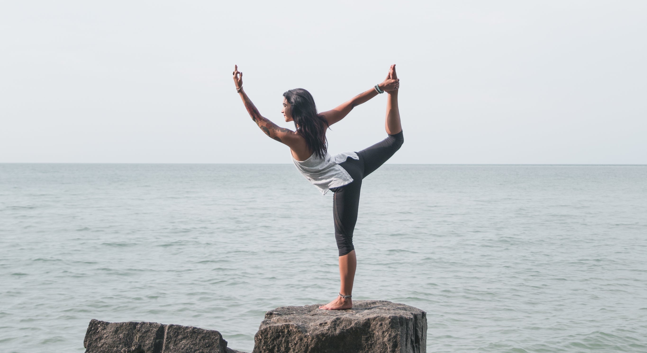 A person doing yoga outdoors as part of a simple daily routine